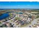 Aerial view of a planned community with lakes and pools, showcasing the neighborhood's design and landscaping at 185 Brookes Pl, Haines City, FL 33844