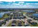 Expansive aerial view of a residential community with lake views, showcasing the neighborhood's layout and amenities at 185 Brookes Pl, Haines City, FL 33844