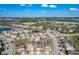 Expansive aerial view of a residential community with mature landscaping and serene ponds on a clear day at 185 Brookes Pl, Haines City, FL 33844