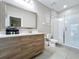 Modern bathroom featuring a glass-enclosed shower and a vanity with a sleek wood cabinet at 185 Brookes Pl, Haines City, FL 33844