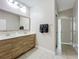 Modern bathroom featuring a double sink vanity with wood cabinets and decorative mirror at 185 Brookes Pl, Haines City, FL 33844