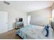 Bedroom with carpet featuring a mirrored dresser and a bed with blue patterned bedding at 185 Brookes Pl, Haines City, FL 33844