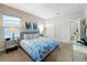 Bedroom featuring a bed with blue patterned bedding and mirrored nightstands with lamps at 185 Brookes Pl, Haines City, FL 33844