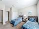 Comfortable bedroom with twin beds, carpet, and a view into the hallway at 185 Brookes Pl, Haines City, FL 33844
