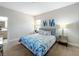 Bedroom featuring a bed with blue patterned bedding and mirrored nightstands with lamps at 185 Brookes Pl, Haines City, FL 33844