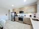 Modern kitchen with stainless steel appliances, sleek wood cabinets, white countertops and a large island at 185 Brookes Pl, Haines City, FL 33844