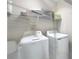 Functional laundry room featuring a washer, dryer, and shelving for organized storage at 185 Brookes Pl, Haines City, FL 33844