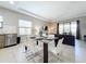 Modern living area with seating for six, and an open layout connected to the dining area and kitchen at 185 Brookes Pl, Haines City, FL 33844