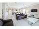 Open-concept living area with tile floors, a comfortable sofa, and a TV at 185 Brookes Pl, Haines City, FL 33844