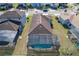 Aerial view of the property showcasing a screened-in pool, backyard, and surrounding neighborhood at 185 Brookes Pl, Haines City, FL 33844