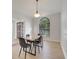 Well-lit dining area with a window view, a wood table, and a contemporary light, accessible from the entry at 2351 Oldfield Dr, Orlando, FL 32837