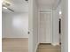 Hallway leading to a bedroom and the front door with light wood flooring and neutral walls at 2351 Oldfield Dr, Orlando, FL 32837