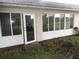 Backyard featuring a door, windows, and green grass at 2724 Shelby Ruth Pl, Saint Cloud, FL 34769
