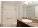 Bathroom featuring a shower-tub combo, dark wood vanity, and a neutral countertop at 2724 Shelby Ruth Pl, Saint Cloud, FL 34769