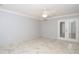 Spacious room featuring white marble-patterned tile flooring and glass paneled doors at 2724 Shelby Ruth Pl, Saint Cloud, FL 34769