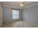 Well-lit bedroom featuring a ceiling fan and marble-patterned tile flooring at 2724 Shelby Ruth Pl, Saint Cloud, FL 34769