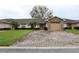 Charming home featuring a brick driveway, stone accents on the garage, and a manicured lawn at 2724 Shelby Ruth Pl, Saint Cloud, FL 34769