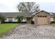 Inviting single-story home featuring a brick driveway, stone accents, and lush green lawn at 2724 Shelby Ruth Pl, Saint Cloud, FL 34769