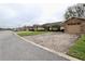 Street view of homes with well-maintained lawns and brick driveways. Each features a stone accent garage at 2724 Shelby Ruth Pl, Saint Cloud, FL 34769