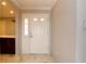 Bright entryway showcasing a white front door with sidelight and marble floors, complemented by neutral walls at 2724 Shelby Ruth Pl, Saint Cloud, FL 34769