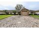 Charming home featuring a stone accent garage, well-maintained lawn, and a spacious brick driveway at 2724 Shelby Ruth Pl, Saint Cloud, FL 34769
