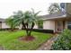 Well maintained front yard with green grass, brick walkway, decorative palm trees and trimmed bushes at 2724 Shelby Ruth Pl, Saint Cloud, FL 34769