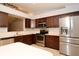 Modern kitchen featuring stainless steel appliances, dark cabinets, light countertops, and a tile backsplash at 2724 Shelby Ruth Pl, Saint Cloud, FL 34769