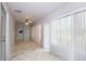 Well-lit living room with marble-patterned tile flooring and sliding glass windows at 2724 Shelby Ruth Pl, Saint Cloud, FL 34769