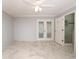 Main bedroom with marble-patterned tile flooring and glass paneled doors to bathroom at 2724 Shelby Ruth Pl, Saint Cloud, FL 34769