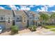 Attractive multi-story townhouses showcasing stone accents, blue exteriors, and well-kept driveways at 2106 Chatham Place Dr, Orlando, FL 32824