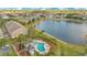 Aerial view of the community pool, lake and multi-Gathering homes on a sunny day at 2106 Chatham Place Dr, Orlando, FL 32824