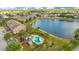 Aerial view of the community pool, lake and multi-Gathering homes on a sunny day at 2106 Chatham Place Dr, Orlando, FL 32824
