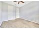 Empty bedroom with neutral walls, carpet, closet and two doors to access the hallway at 2106 Chatham Place Dr, Orlando, FL 32824