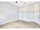 A simple bedroom features neutral walls, carpet, and a double-door closet at 2106 Chatham Place Dr, Orlando, FL 32824
