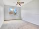 An empty bedroom with neutral walls, carpet, ceiling fan and a window with natural light at 2106 Chatham Place Dr, Orlando, FL 32824