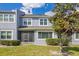 Charming two-story home with a blue exterior, green lawn and screened front porch at 2106 Chatham Place Dr, Orlando, FL 32824