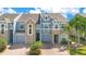 Attractive multi-story townhouses showcasing stone accents, blue exteriors, and well-kept driveways at 2106 Chatham Place Dr, Orlando, FL 32824