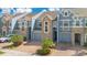 Attractive townhome with two-car garage, stone accents, and well manicured landscaping at 2106 Chatham Place Dr, Orlando, FL 32824