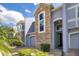 A townhome exterior with stone accents, a dark-colored front door, and a two-car garage at 2106 Chatham Place Dr, Orlando, FL 32824
