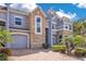 A close view of the townhome's well-maintained brick driveways, front yard landscaping and stone facade at 2106 Chatham Place Dr, Orlando, FL 32824