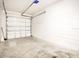 Clean and spacious garage with white block walls, concrete floor, and an insulated garage door at 2106 Chatham Place Dr, Orlando, FL 32824