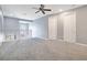 Hallway boasts neutral paint, ceiling fan and access to multiple rooms at 2106 Chatham Place Dr, Orlando, FL 32824