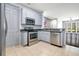 A close view of the kitchen, featuring granite countertops, stainless appliances and tiled floor at 2106 Chatham Place Dr, Orlando, FL 32824
