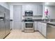 Kitchen with stainless steel appliances, ample counter space, and grey cabinets at 2106 Chatham Place Dr, Orlando, FL 32824