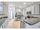A well-appointed kitchen with grey cabinets, stainless steel appliances, and tiled floors at 2106 Chatham Place Dr, Orlando, FL 32824