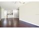 Open living area with dark hardwood flooring and open access to kitchen at 2106 Chatham Place Dr, Orlando, FL 32824