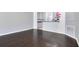 Open living area with dark hardwood flooring and access to kitchen at 2106 Chatham Place Dr, Orlando, FL 32824