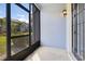 An enclosed patio with a screened wall overlooks the lovely landscaping at 2106 Chatham Place Dr, Orlando, FL 32824