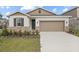 Two-story house with stone accents and a two-car garage at 3345 Chicory Ct, Lake Hamilton, FL 33851