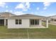 House exterior features a covered patio and grassy yard at 3345 Chicory Ct, Lake Hamilton, FL 33851